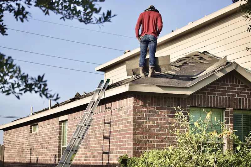 Professional roofer working on a residential roof in Villa Chase